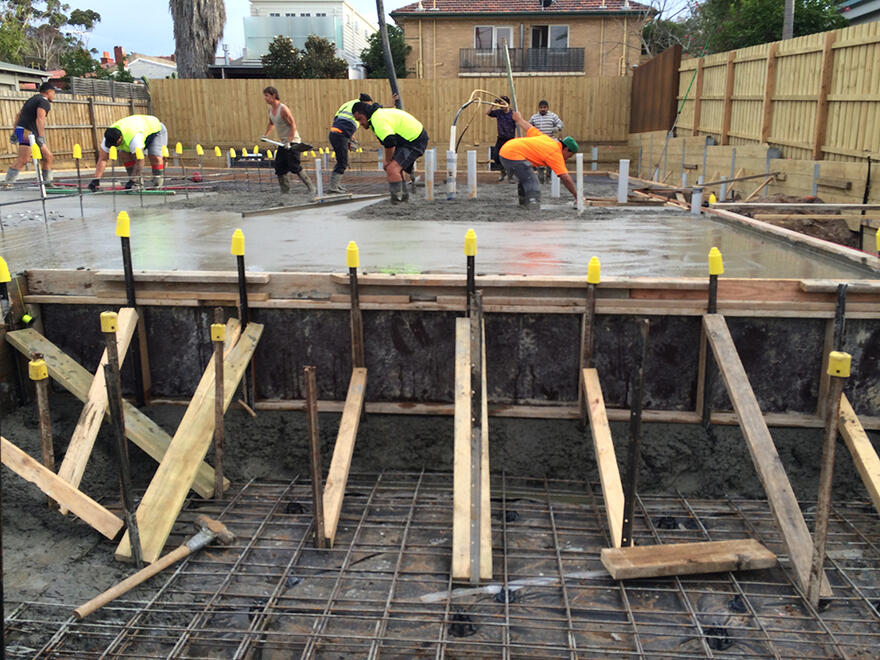 House concrete foundation pour in progress Construction team pouring concrete for a residential house slab in Melbourne