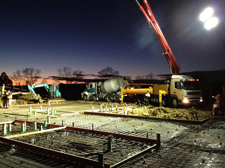 Night slab pour with concrete truck Concrete truck and pump pouring slab foundations at night in Melbourne